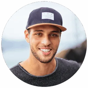 Smiling young man in a navy snapback cap, team member at Sparrow Media web agency in Central NY